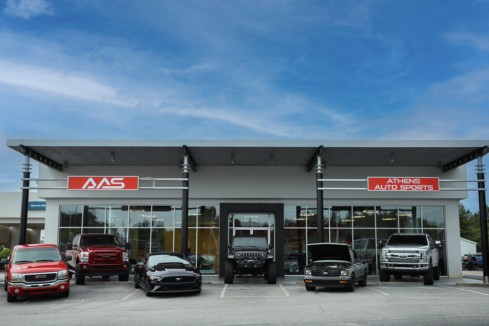 Athens Auto Sports Storefront with Customized Cars and Trucks